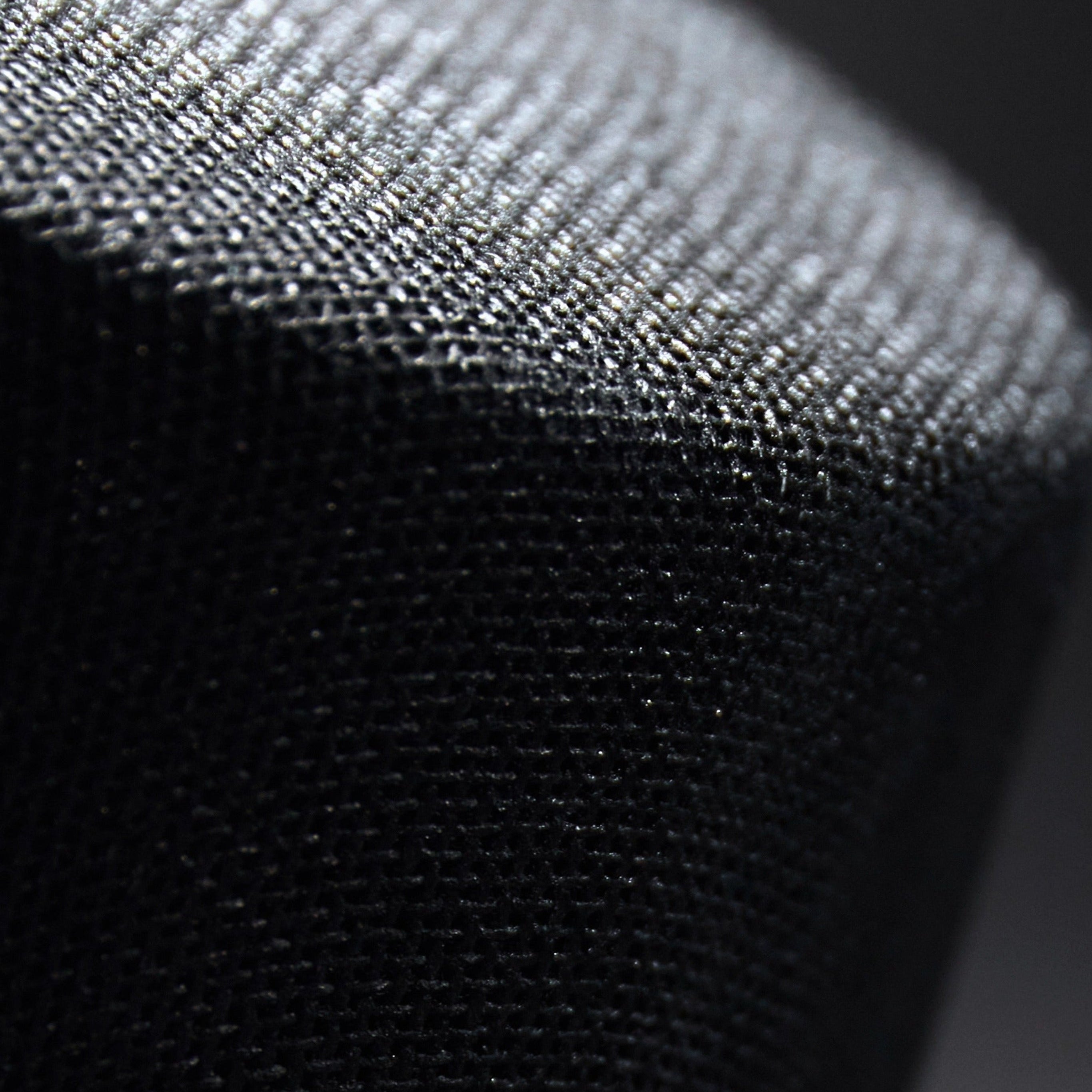 Close-up of a textured black and gray fabric surface